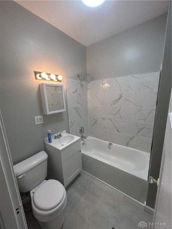 full bathroom featuring tiled shower / bath, vanity, and toilet