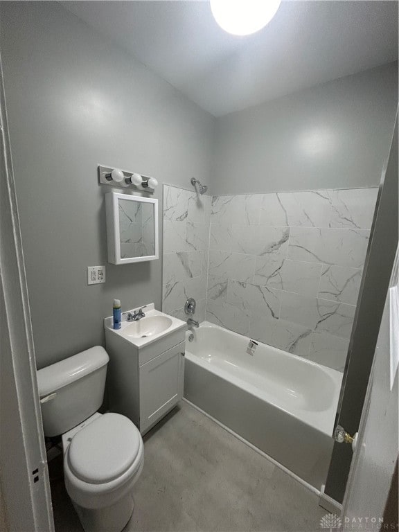 full bathroom featuring vanity, tiled shower / bath combo, and toilet