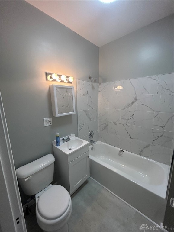 full bathroom featuring vanity, tiled shower / bath combo, and toilet