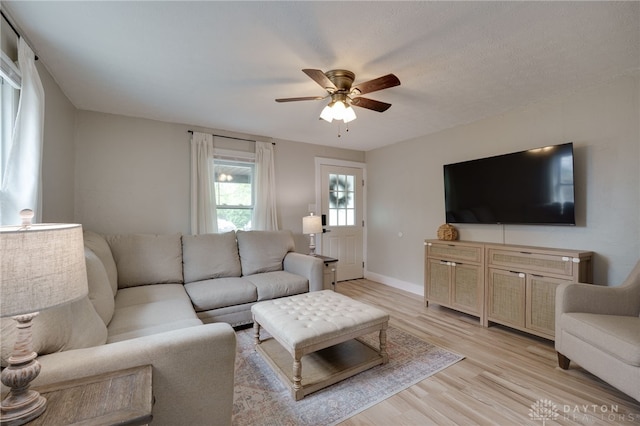 living room featuring ceiling fan and light hardwood / wood-style floors