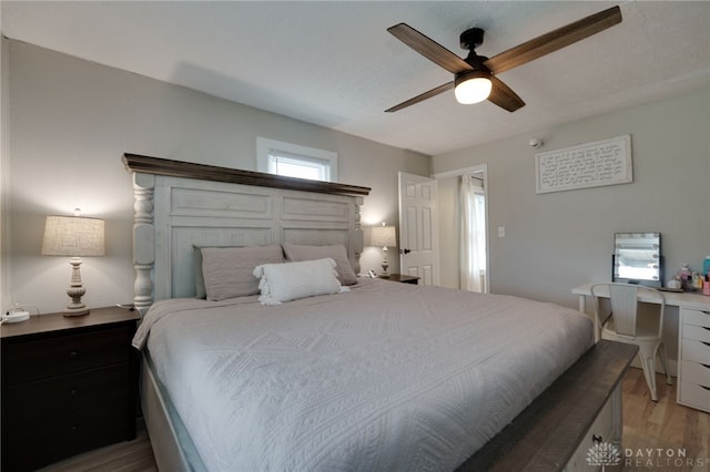 bedroom with hardwood / wood-style floors and ceiling fan