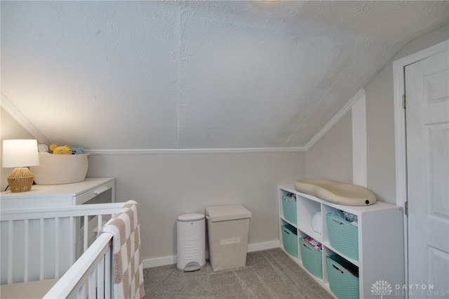 carpeted bedroom featuring vaulted ceiling and a textured ceiling