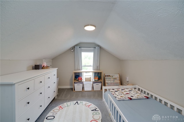 carpeted bedroom featuring lofted ceiling and a textured ceiling