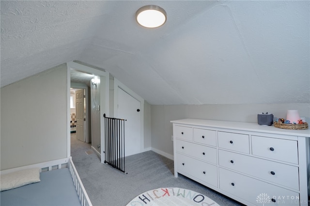 bonus room with vaulted ceiling, light colored carpet, and a textured ceiling