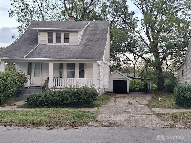 view of front of home with an outdoor structure, a garage, and a porch