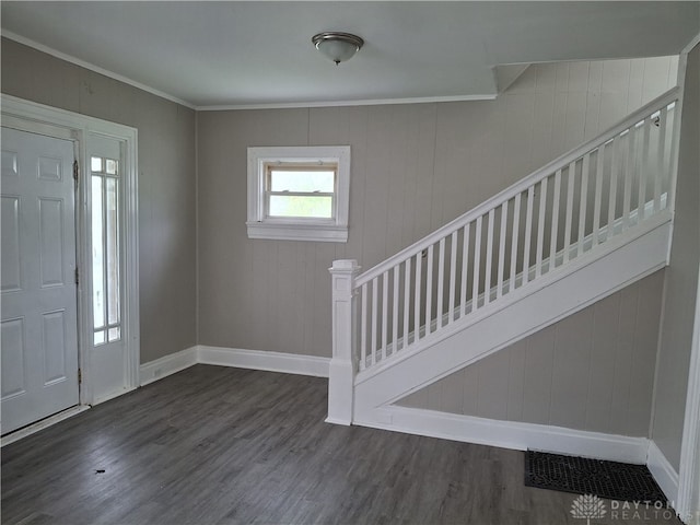 entrance foyer with wood walls and dark hardwood / wood-style flooring