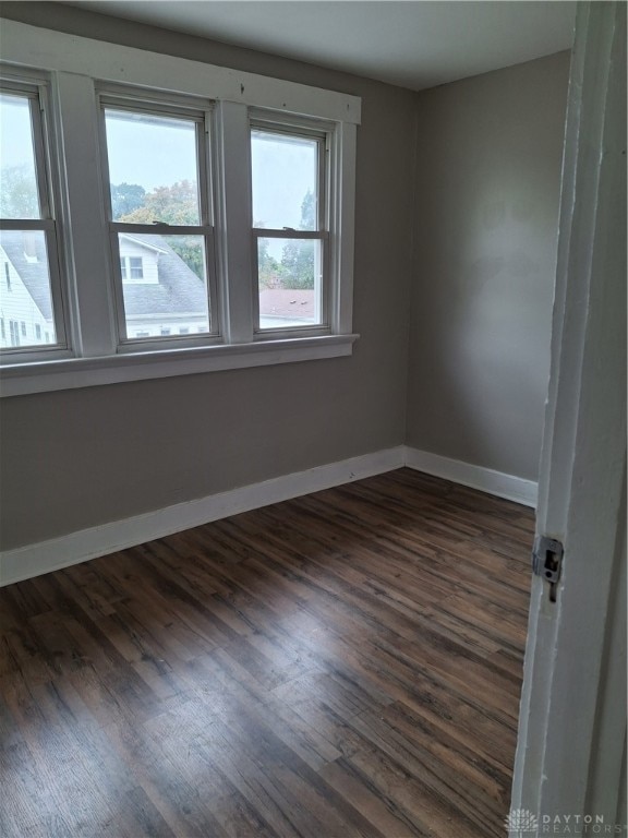 empty room with dark hardwood / wood-style floors