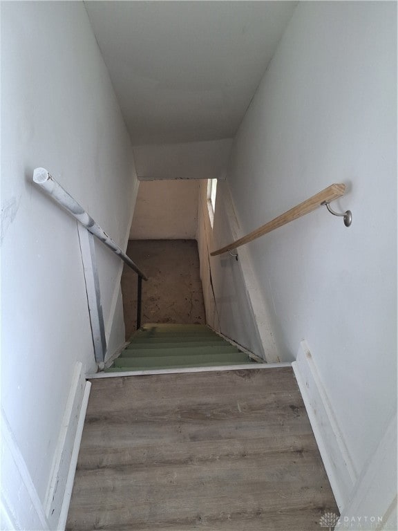 stairway with hardwood / wood-style flooring