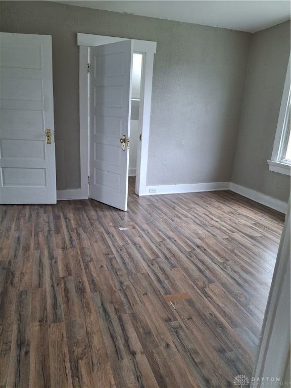 empty room featuring dark wood-type flooring