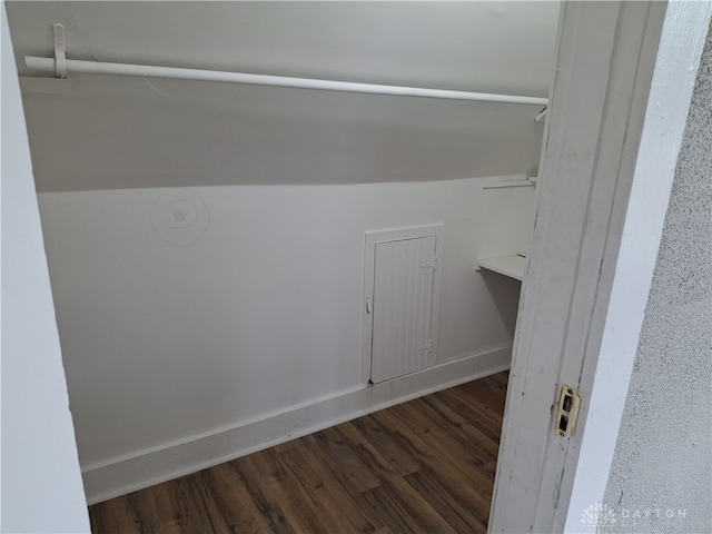 laundry area with dark wood-type flooring