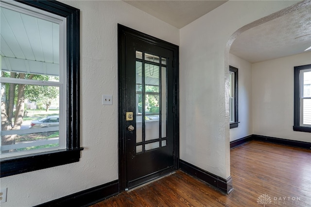 foyer featuring a textured ceiling and dark wood-type flooring