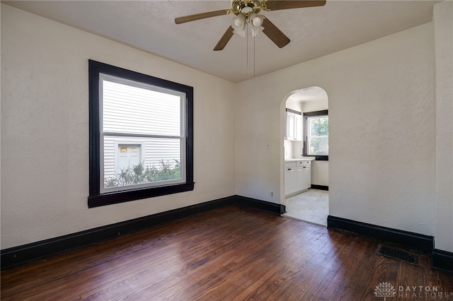 unfurnished room with ceiling fan and dark hardwood / wood-style floors