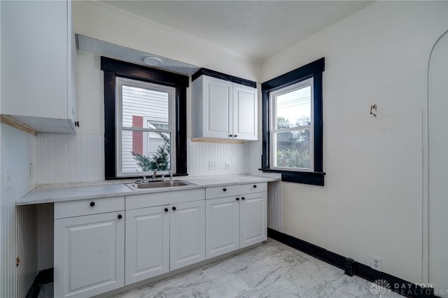 kitchen featuring white cabinets and sink