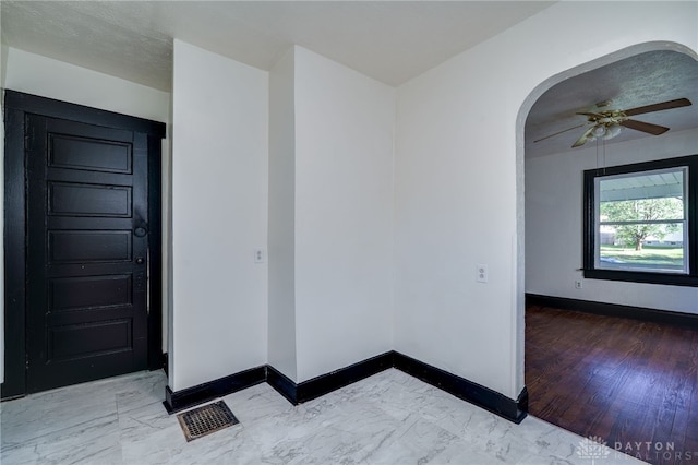 spare room featuring ceiling fan and hardwood / wood-style flooring