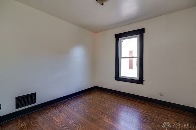 spare room featuring dark hardwood / wood-style floors