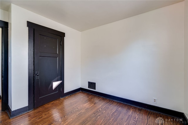 empty room featuring dark hardwood / wood-style flooring