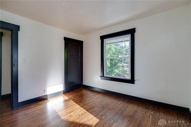 spare room featuring dark hardwood / wood-style floors