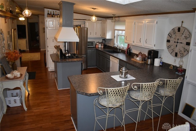 kitchen with a kitchen breakfast bar, white cabinetry, a center island, and hanging light fixtures