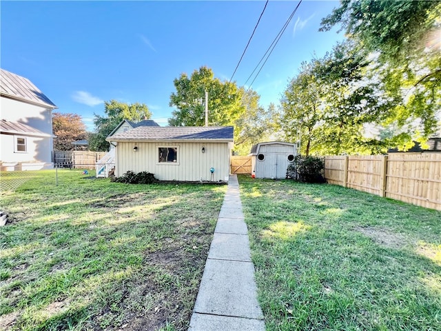 rear view of property featuring a yard and a shed