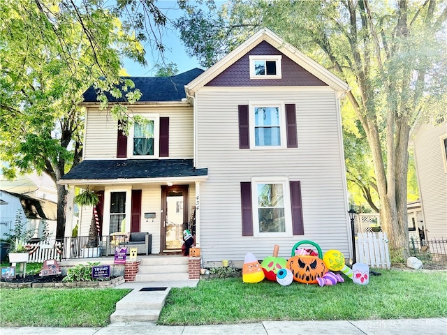 view of front facade with a front yard and a porch