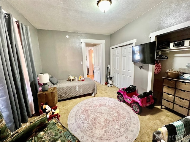 carpeted bedroom featuring a textured ceiling