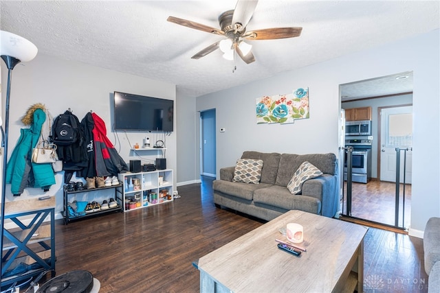 living room with a textured ceiling, dark hardwood / wood-style floors, and ceiling fan