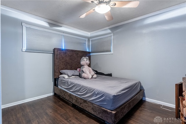 bedroom featuring ceiling fan, crown molding, dark hardwood / wood-style floors, and a textured ceiling