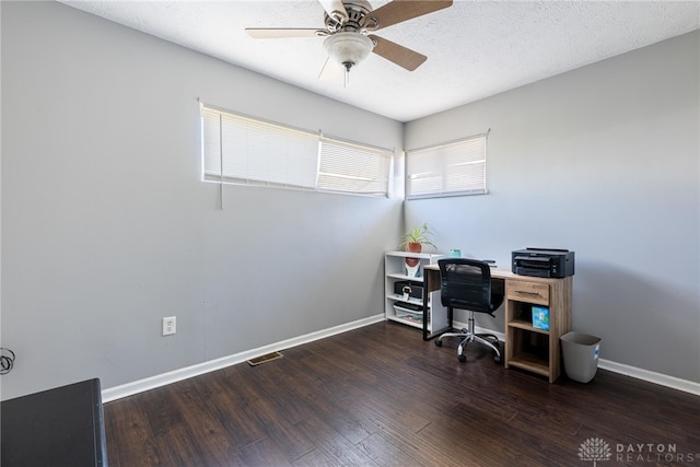 office with a textured ceiling, baseboards, dark wood-style floors, and a ceiling fan