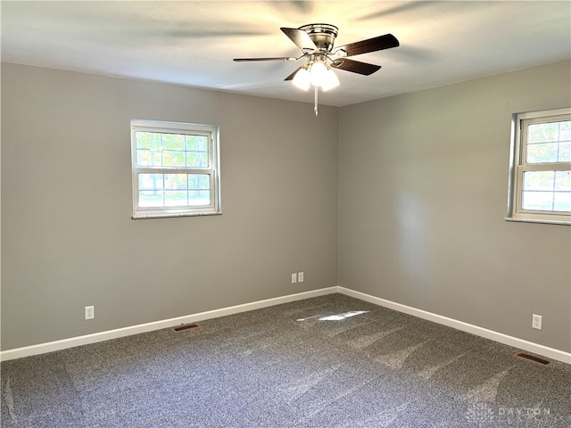 unfurnished room featuring carpet, ceiling fan, and a healthy amount of sunlight