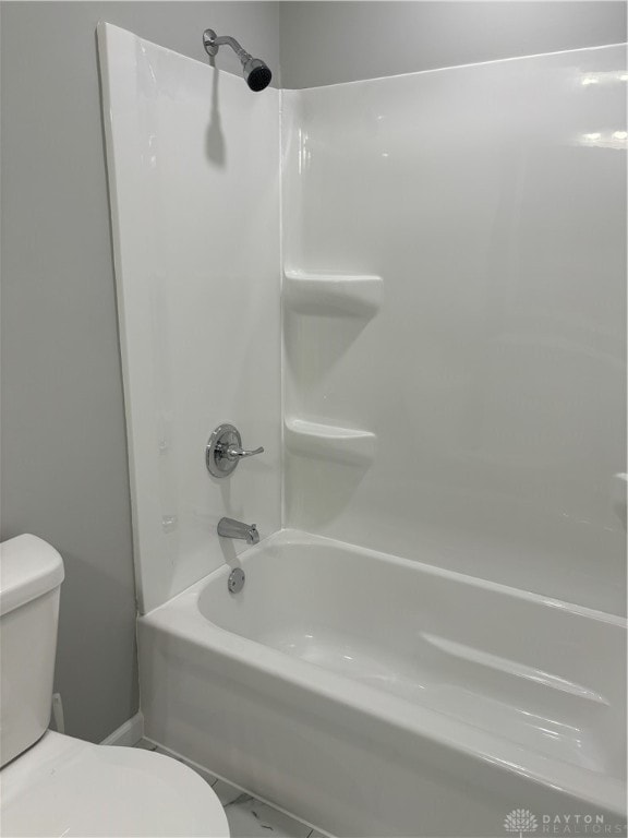 bathroom featuring shower / bathing tub combination and toilet