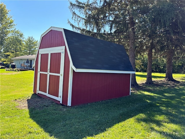 view of outdoor structure featuring a lawn