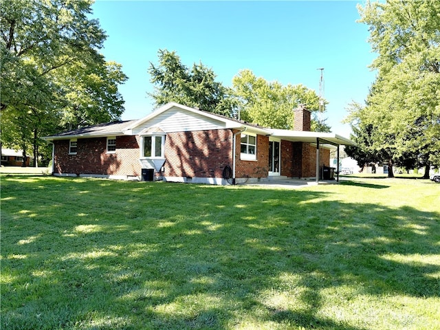 back of property featuring a lawn