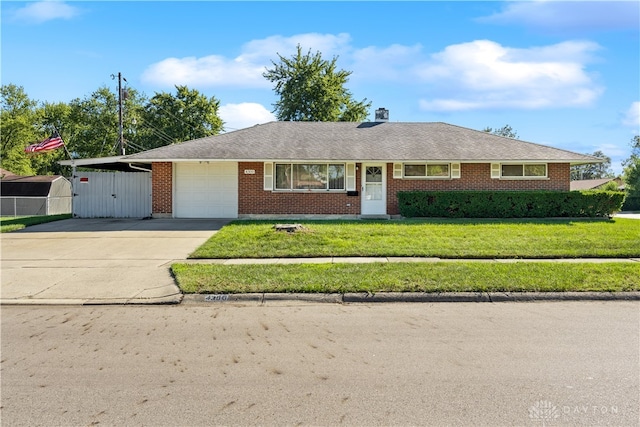 ranch-style house featuring a front yard and a garage