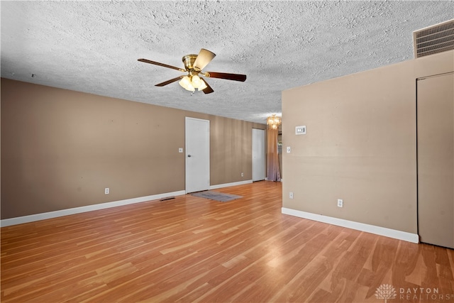 empty room with ceiling fan, a textured ceiling, and light hardwood / wood-style flooring