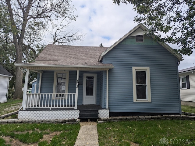 bungalow-style home with a front lawn and a porch