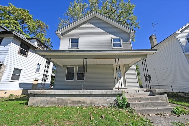 back of property with a porch