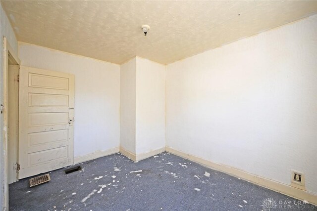 empty room with a textured ceiling