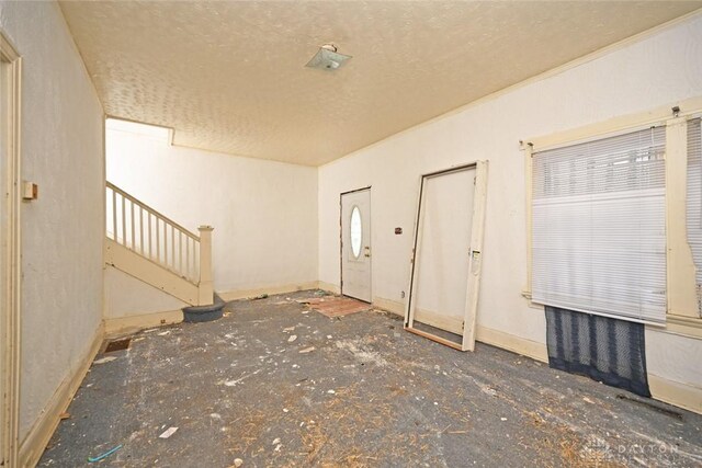 foyer featuring a textured ceiling