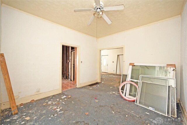 spare room with a textured ceiling and ceiling fan