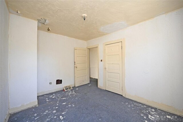 spare room featuring a textured ceiling