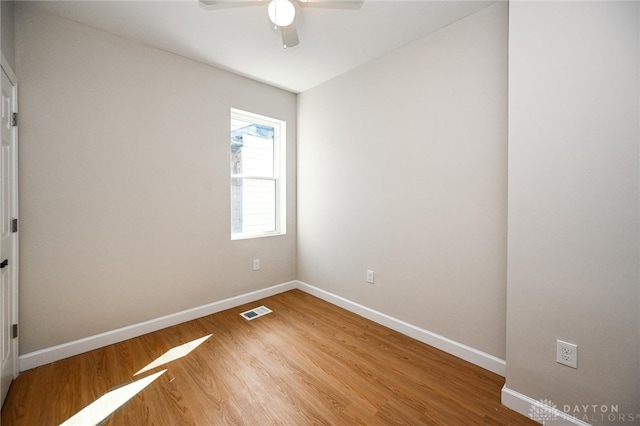 unfurnished room with ceiling fan and hardwood / wood-style floors