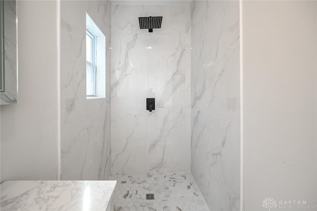 bathroom with a tile shower