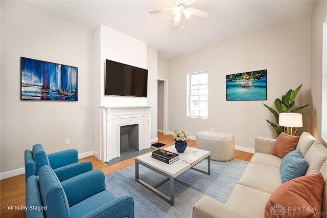 living room featuring ceiling fan and light hardwood / wood-style flooring