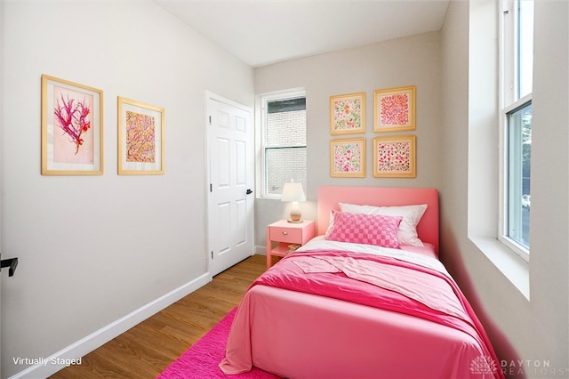 bedroom with wood-type flooring