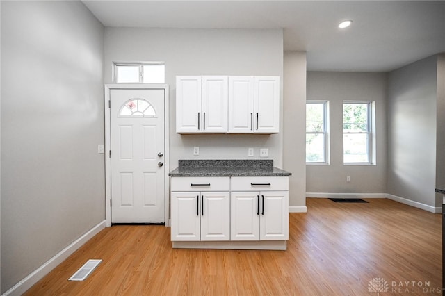 kitchen featuring white cabinets and light wood-type flooring