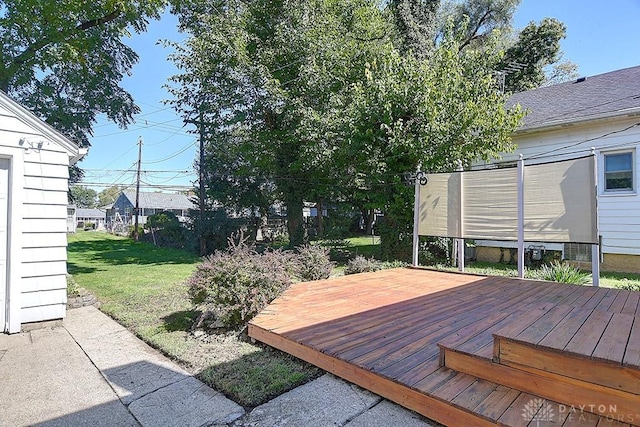 wooden deck with a lawn