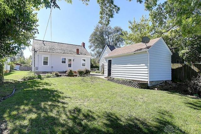 rear view of house featuring a yard