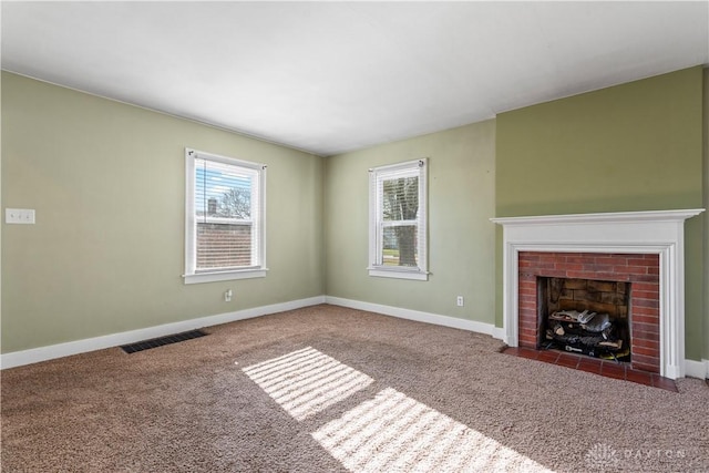 unfurnished living room featuring carpet and a fireplace