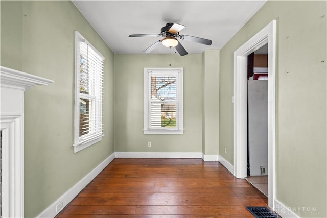 unfurnished bedroom featuring ceiling fan and dark wood-type flooring