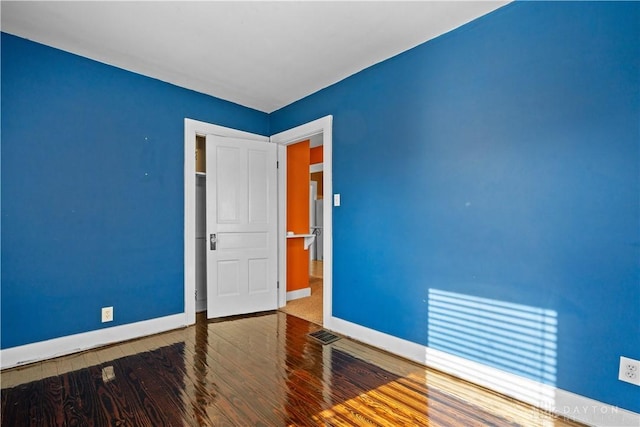 empty room with hardwood / wood-style flooring